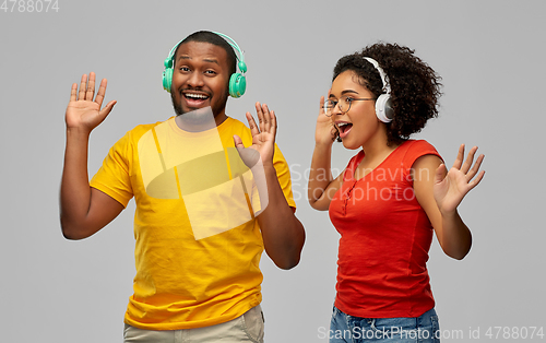 Image of african american couple with headphones dancing