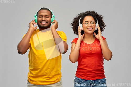 Image of happy african american couple with headphones