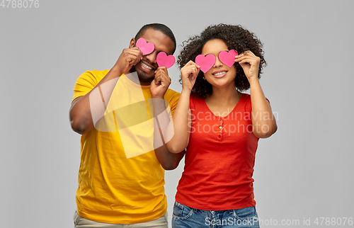 Image of happy african american couple with hearts