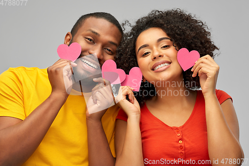 Image of happy african american couple with hearts