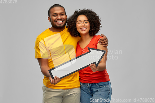 Image of happy african american couple with arrow to right