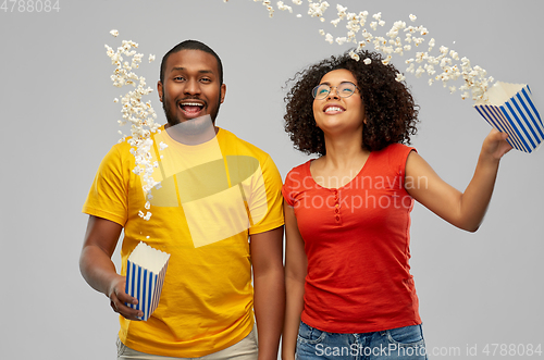 Image of happy african american couple with popcorn