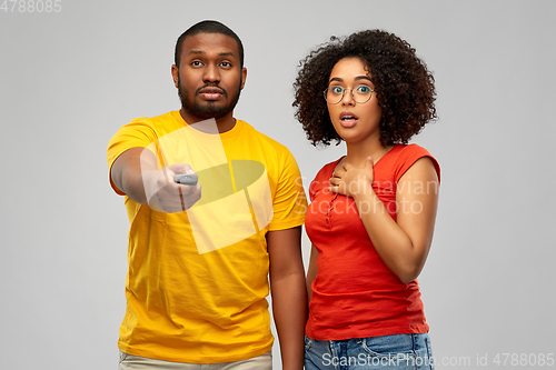 Image of african american couple with tv remote control