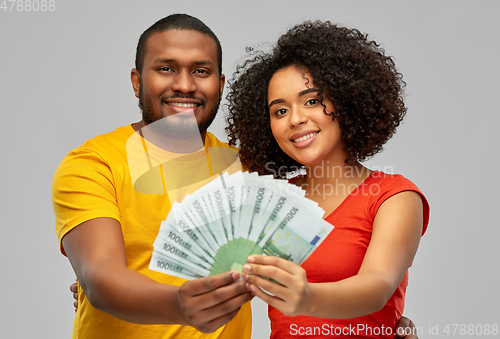 Image of happy african american couple with euro money