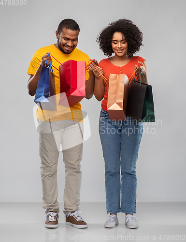 Image of happy african american couple with shopping bags