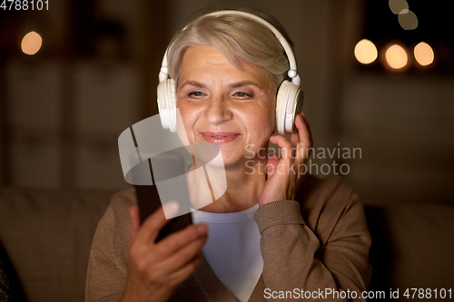 Image of senior woman in headphones listening to music