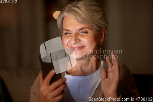 Image of happy old woman with smartphone having video call