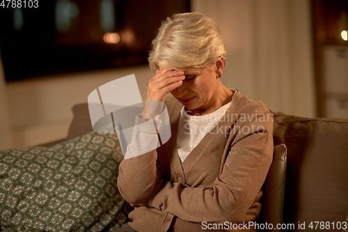 Image of unhappy senior woman suffering from headache