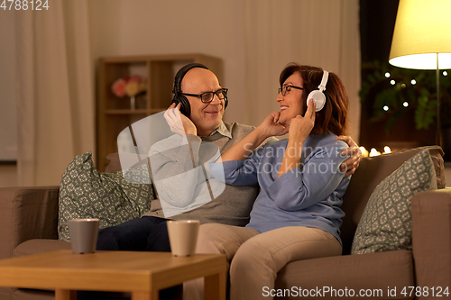 Image of senior couple with headphones listening to music