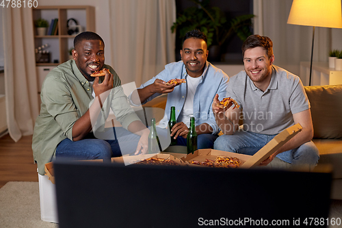 Image of happy male friends with beer eating pizza at home