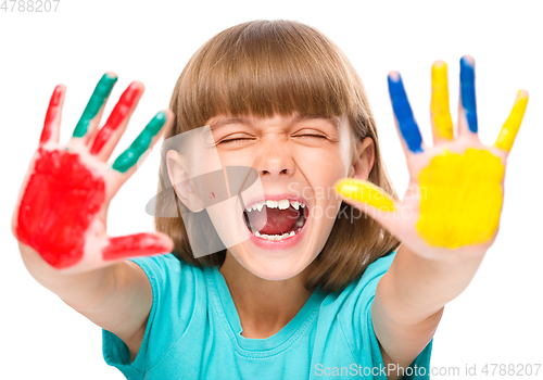 Image of Portrait of a cute girl playing with paints