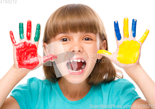 Image of Portrait of a cute girl playing with paints