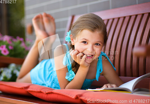 Image of Little girl is reading a book