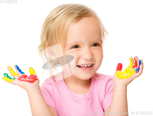 Image of Portrait of a cute little girl playing with paints