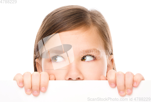 Image of Little girl is looking from out blank board