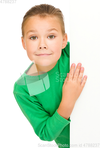 Image of Little girl is looking from out blank board