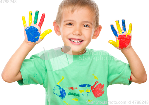 Image of Portrait of a cute boy playing with paints