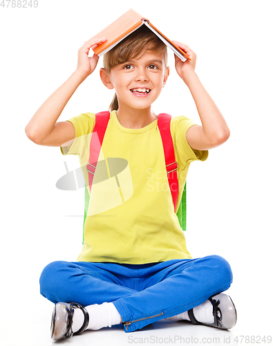 Image of Portrait of a cute little schoolgirl with backpack
