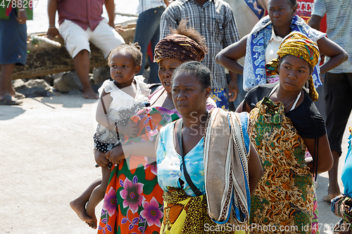 Image of Malagasy woman waiting for transport ship, Nosy Be, Madagascar