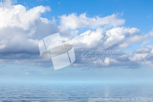 Image of blue sky with white clouds over the sea