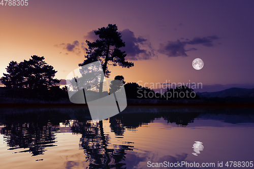 Image of moon with lake reflections dark scenery