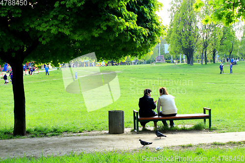 Image of women have a rest on the bench in city park