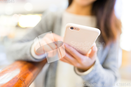 Image of Woman working on mobile phone
