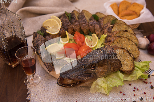 Image of Stuffed pike with vegetables and greens.