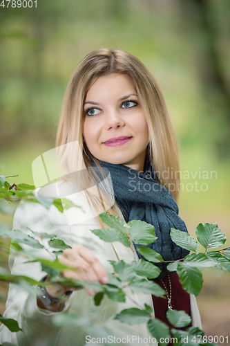 Image of young woman standing in the green forest