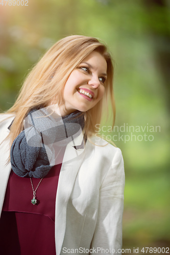 Image of young woman standing in the green forest