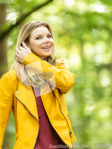 Image of young woman standing in the green forest