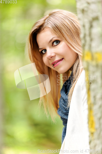Image of young woman standing in the green forest