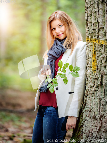Image of young woman standing in the green forest