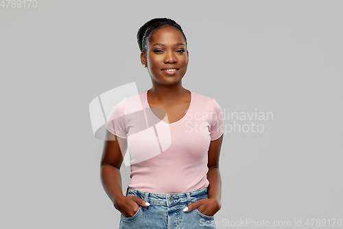 Image of happy african american woman over grey background