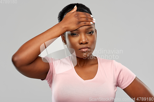 Image of african american woman having headache or fever