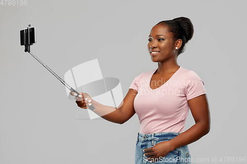 Image of african american woman taking selfie by smartphone