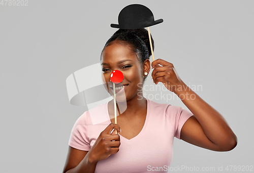 Image of happy african american woman with red clown nose