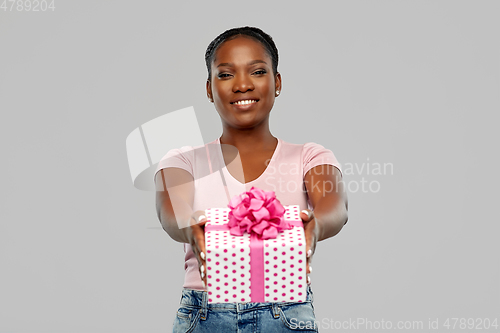 Image of happy african american woman with birthday present