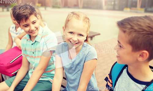 Image of group of happy elementary school students talking