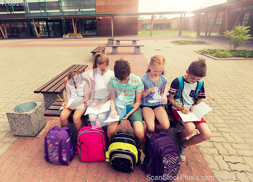 Image of group of happy elementary school students outdoors