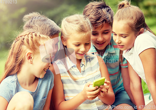 Image of kids or friends with smartphone in summer park