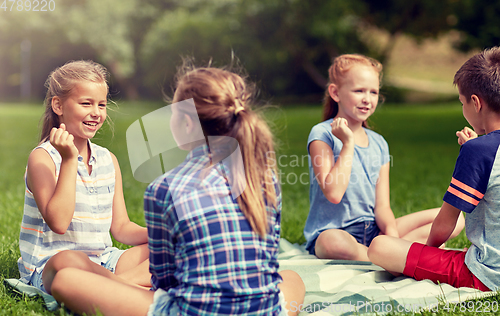 Image of happy kids playing rock-paper-scissors game