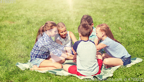 Image of group of happy kids putting hands together