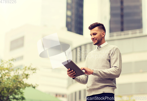 Image of happy man with tablet pc computer in city