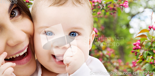 Image of mother with baby over spring garden background