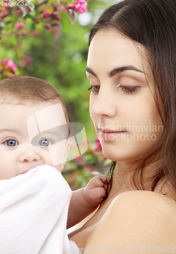 Image of mother with baby over spring garden background