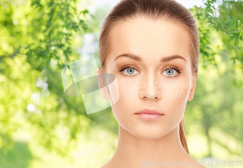 Image of face of beautiful woman over background