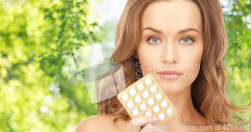 Image of beautiful woman with medicine pills