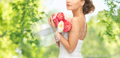 Image of young woman or bride with bouquet of flowers