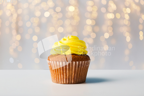 Image of close up of cupcake or muffin with yellow frosting